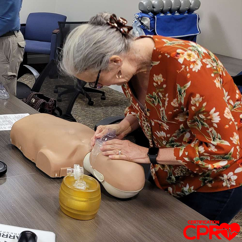 CPR training session with adult mannequin in Atlanta.