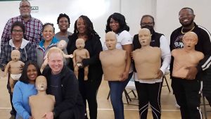 Group CPR training session with mannequins in Atlanta.