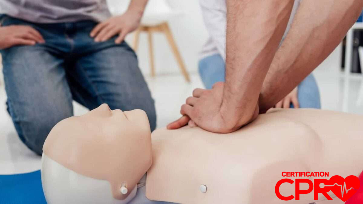 CPR training session with a man practicing on a mannequin in Atlanta.